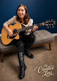 a girl sitting on a couch with an acoustic guitar